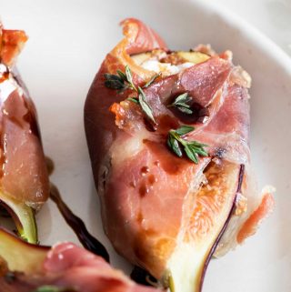 Fig wrapped in prosciutto on a plate